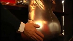 girl in shiny outfit pegging business man
